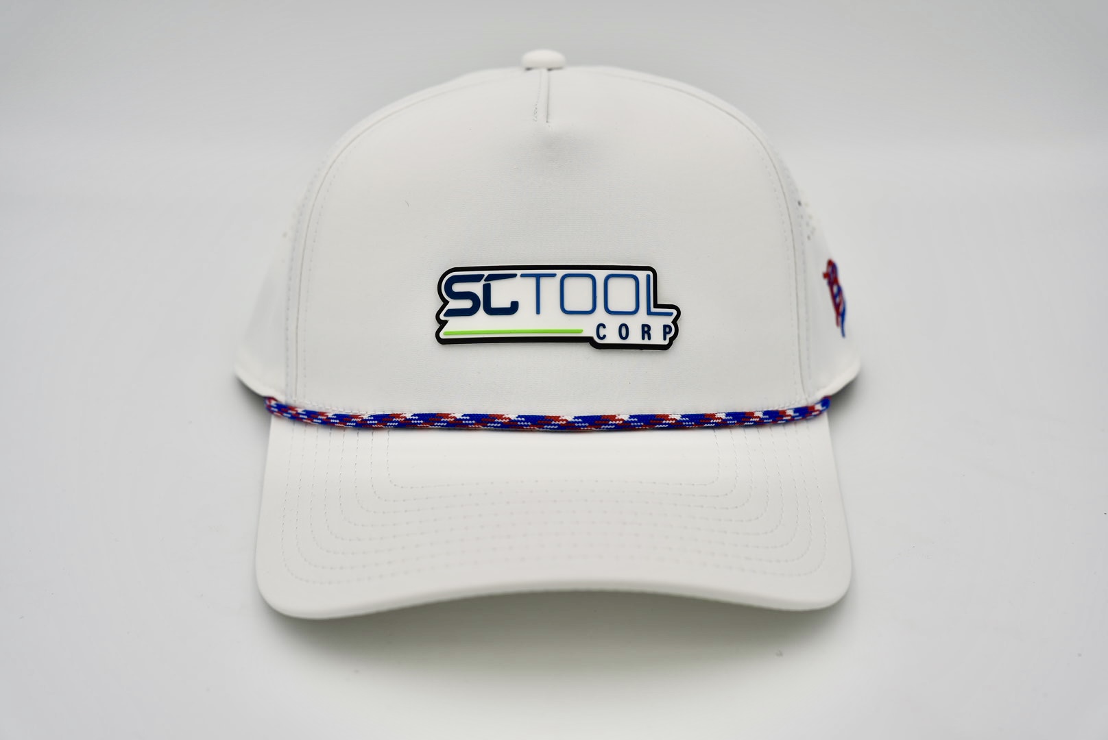 Performance Golf Hat – White with Red, White, and Blue Rope Cord